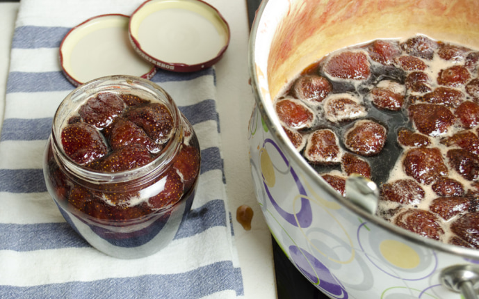 Strawberry jam: Pouring the hot jam into sterile jars Strawberry jam: Pouring the hot jam into sterile jars