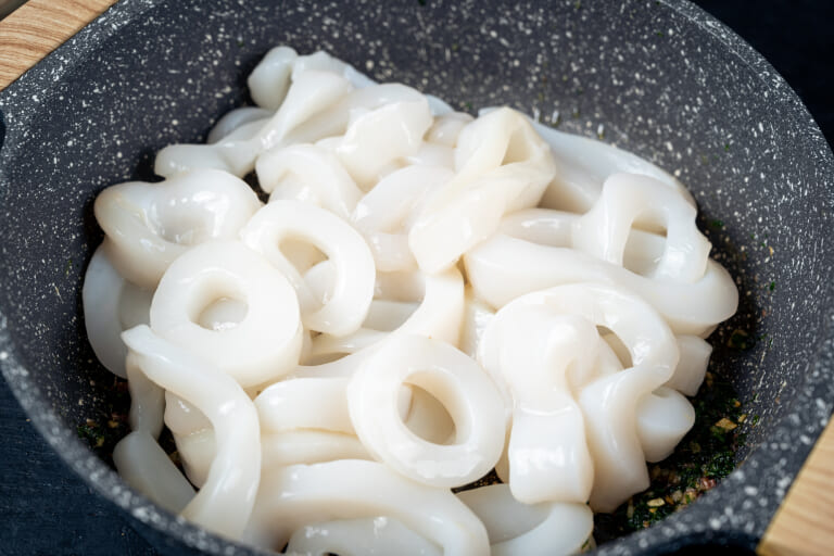Adding calamari to the pan