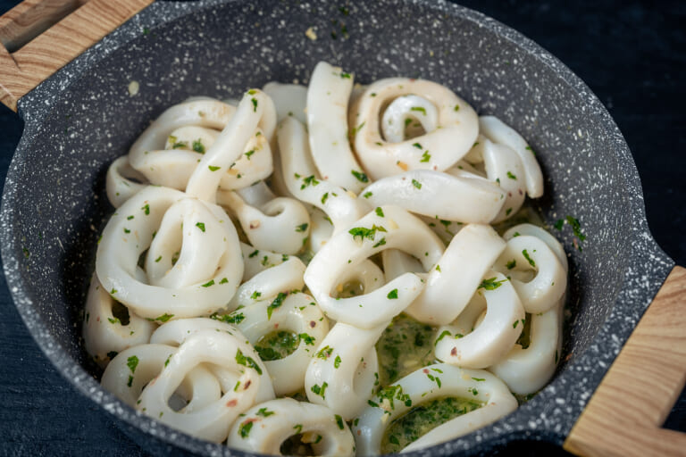 Sautéing calamari in the pan
