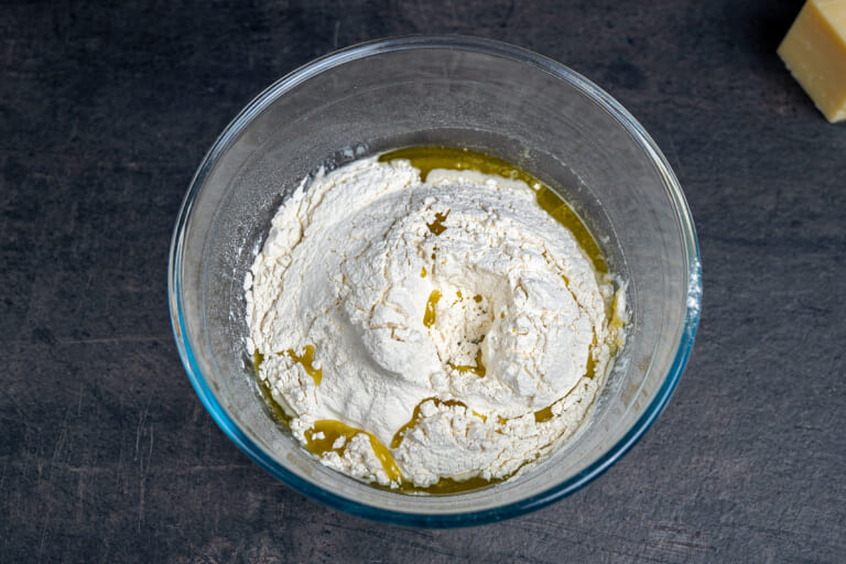 Combining ingredients for bread dough in a bowl Combining ingredients for bread dough in a bowl