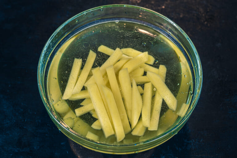 Potato sticks soaking in water