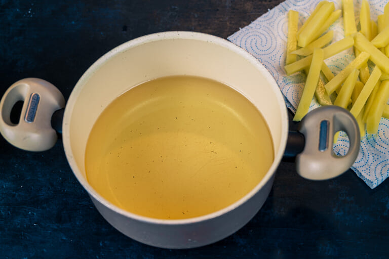 Pouring oil into a pot or deep saucepan