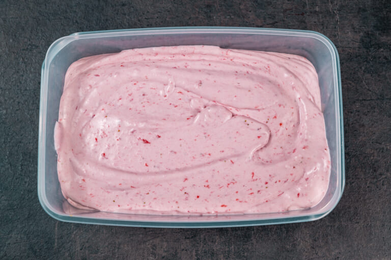 No churn strawberry ice cream in a plastic container