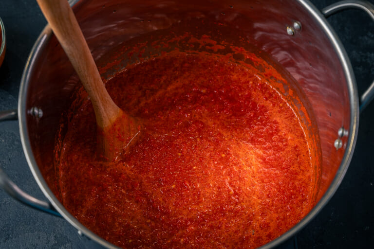 Put the ground peppers and tomatoes on the heat