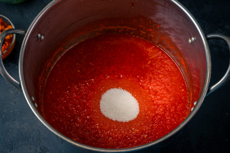 Add sugar, salt, and oil to the cooked adjika