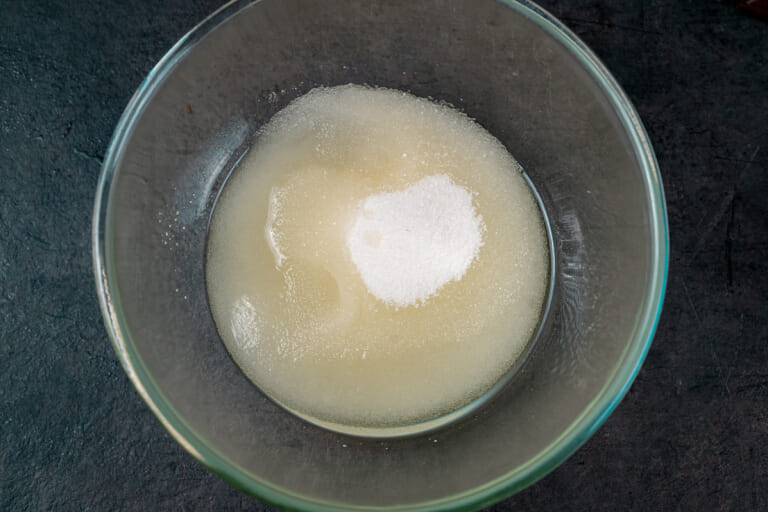Sugar, vegetable oil, and vanilla extract mixed in a large bowl Sugar, vegetable oil, and vanilla extract mixed in a large bowl