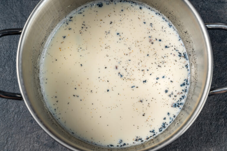 Heated milk with vanilla seeds for Creme Anglaise Heated milk with vanilla seeds for Creme Anglaise