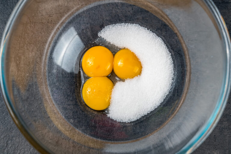 Chicken egg yolks with sugar in a bowl Chicken egg yolks with sugar in a bowl