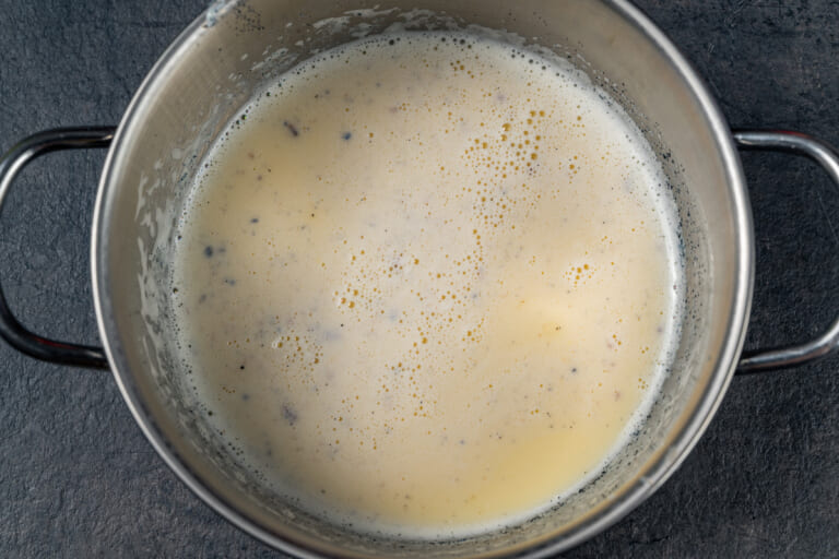 Crème Anglaise in a pot on the stove Crème Anglaise in a pot on the stove