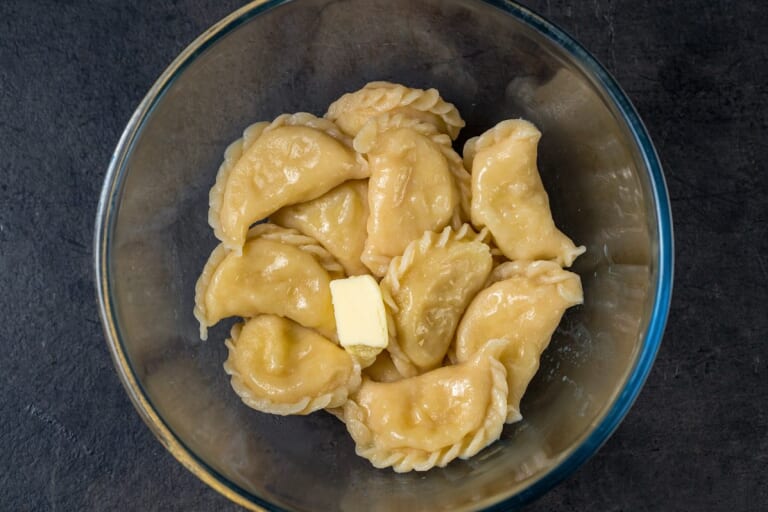 Vareniki in a bowl with butter