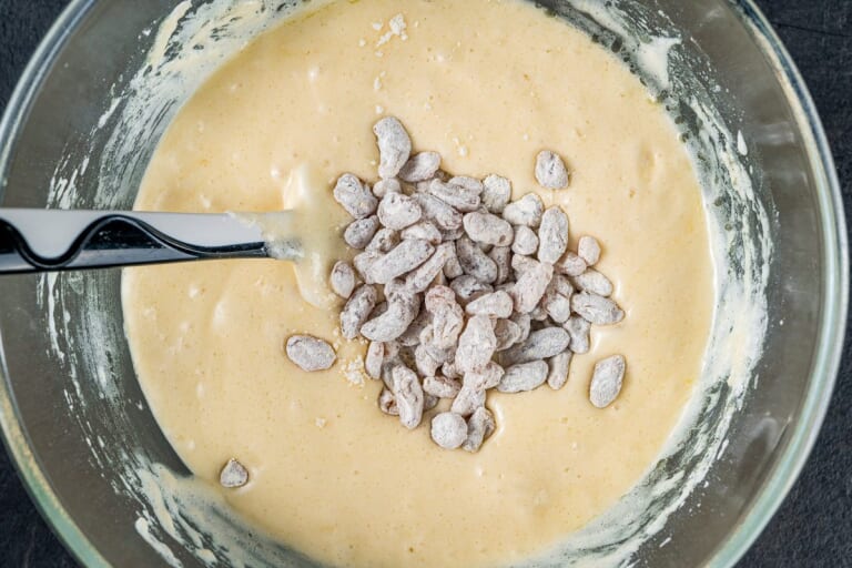 Batter for cake with flour-coated raisins