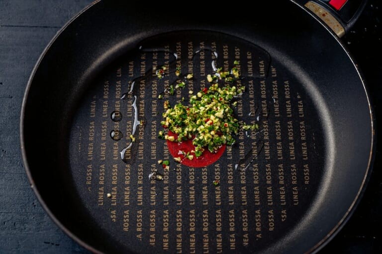 Minced garlic, hot pepper and parsley in a pan