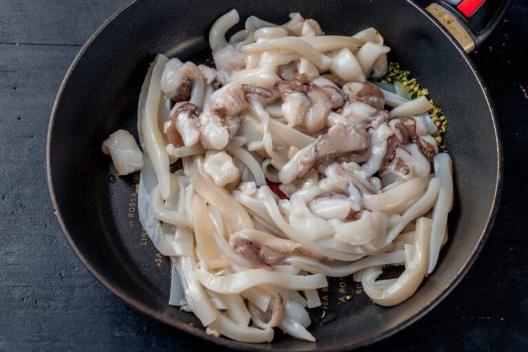 Pieces of cuttlefish in a heated pan