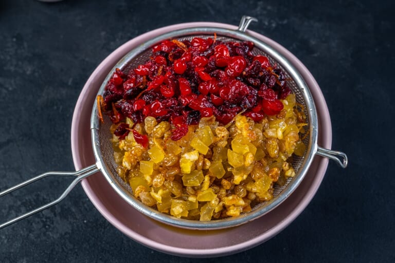 Draining brandy from candied fruits and dried fruits for British Christmas cake