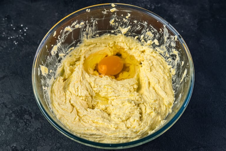 British Christmas cake adding eggs one at a time to the butter mixture