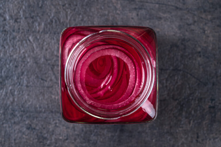 Pickled red onions in cooled marinade