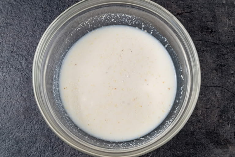 Cream of Wheat soaking in milk in a bowl for the farmer's cheese bake.