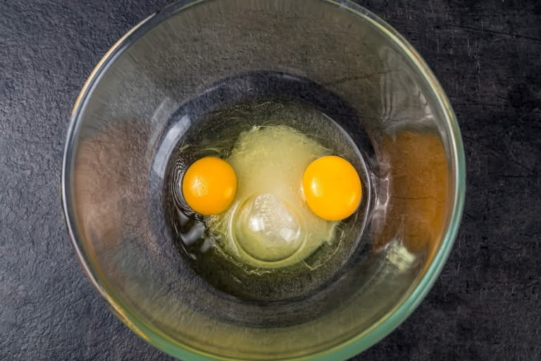 Eggs and sugar whisked together for the raisin Zapekanka.