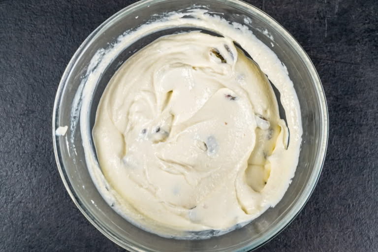 Homogenous batter for Farmer's Cheese and Raisin Bake with evenly distributed raisins.