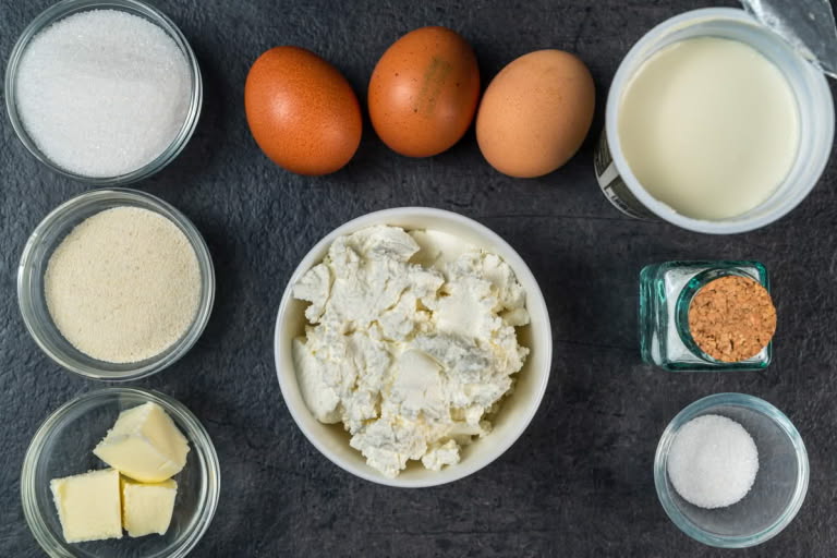 Ingredients for Classic Russian Farmer's Cheese Cake (Zapekanka): farmer's cheese, Cream of Wheat, sour cream, eggs, sugar, butter, and vanilla. Ingredients for Classic Russian Farmer's Cheese Cake (Zapekanka): farmer's cheese, Cream of Wheat, sour cream, eggs, sugar, butter, and vanilla.
