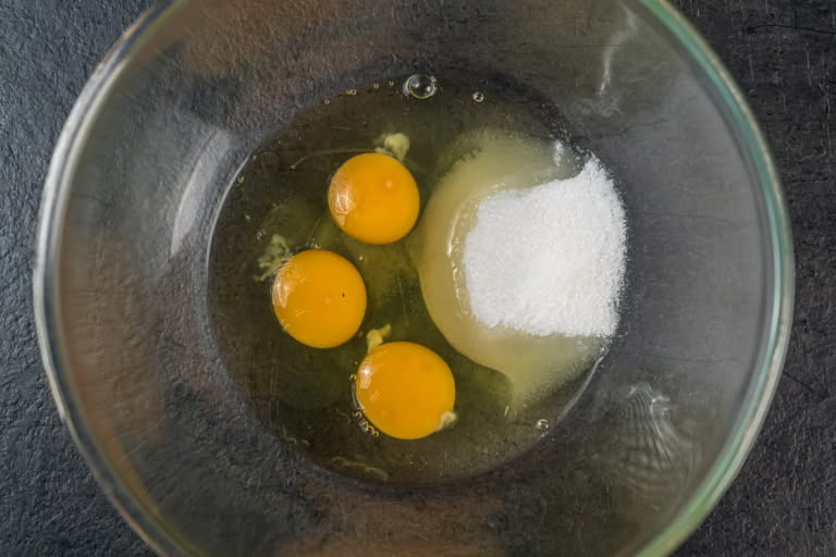 Step 2: Whisking eggs with sugar to create a frothy mixture for farmer's cheese bake. Step 2: Whisking eggs with sugar to create a frothy mixture for farmer's cheese bake.