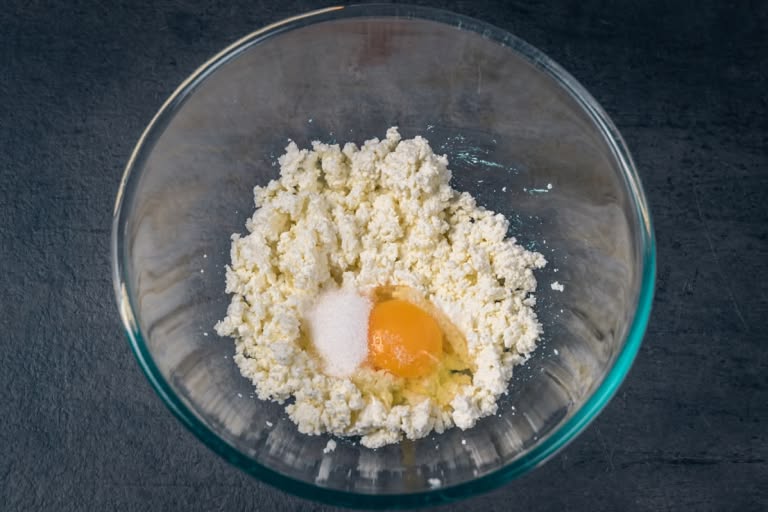 Mixing the egg and farmer's cheese mixture with a fork until uniform.