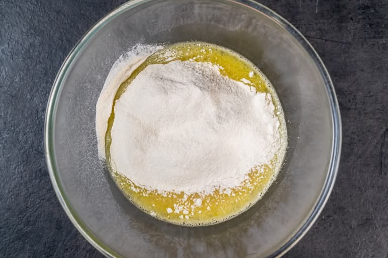 Mixing sifted flour into the liquid batter base for nalysnyky